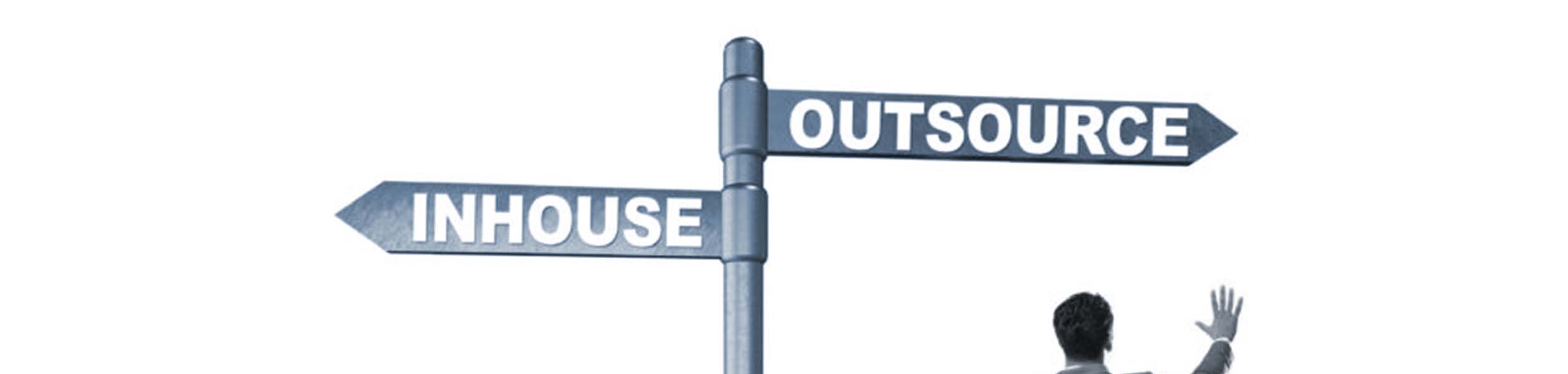 Image of a signpost pointing in two directions. One is in-house and the other outsource.