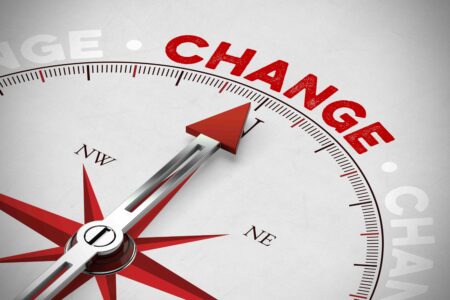 Red arrow of a compass pointing to Change to indicate the impact of the UK late payment reform.